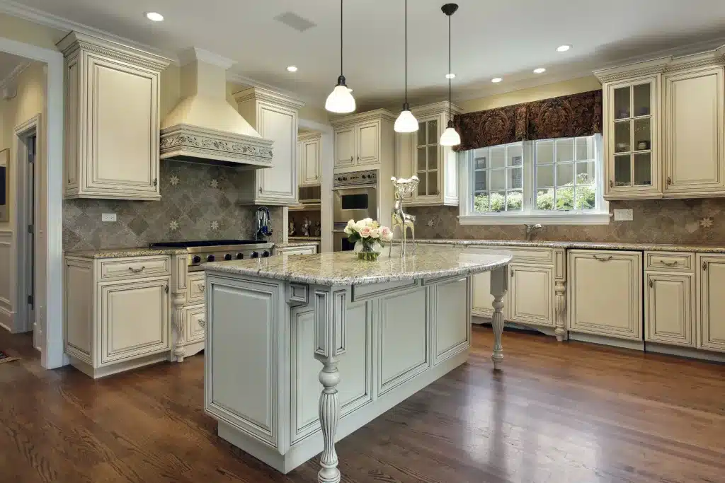 Kitchen in luxury home with large granite island. What to be Prepared for When Painting Your Cabinets